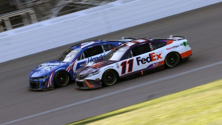 No. 11 FedEx Express Toyota, and Kyle Larson, driver of the No. 5 HendrickCars.com Chevrolet, race during the NASCAR Cup Series AdventHealth 400 at Kansas Speedway (Jonathan Bachman | Getty Images)