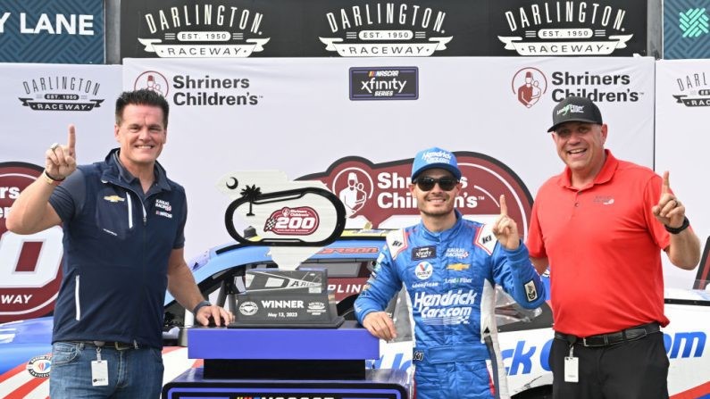 Kyle Larson, driver of the No. 10 HendrickCars.com Chevrolet, celebrates with Matt Kaulig, owner of Kaulig Racing and Chris Rice, President of Kaulig Racing, in Victory Lane after winning the NASCAR Xfinity Series Shriners Children's 200 at Darlington Raceway. IMAGE CREDIT: Logan Riely, Getty Images